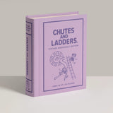 Purple book titled 'Chutes and Ladders' on a light gray background