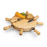Wooden cheese board with handles, accompanied by cheese, crackers, and a knife on a white background.