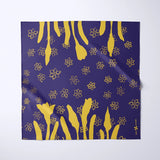 A square scarf with a deep purple background and a gold floral pattern, displayed flat against a light gray background.