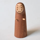 A wooden bottle opener shaped like the character No-Face from Spirited Away, photographed against a plain light background.