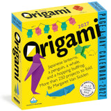 A bright yellow Origami 2027 page-a-day calendar box with colorful origami bird illustrations and text describing folding projects, photographed on a white background.