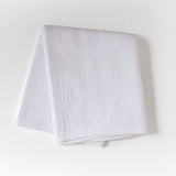 White textured fabric on a light gray background