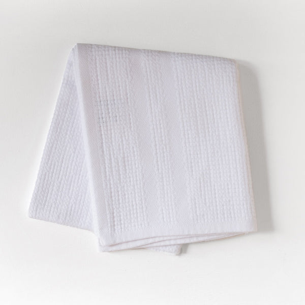 White textured fabric on a light gray background