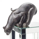 Bronze finish resin cat sculpture on a mirrored table