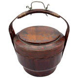 Vintage Chinese basket crafted of wood with a bamboo handle. Painted red with faded imagery.