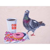 A stylized illustration of a pigeon standing beside a white coffee cup with red 'DUNK' lettering and a pink-frosted donut wrapped in paper with colorful text, all on a pale wood-grain background.