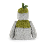 Plush toy resembling a creature with a green hat and scarf on a white background