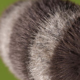 Close-up of gray fur with a blurred green background