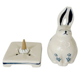 Ceramic rabbit incense burner with a cone-shaped incense holder on a white background