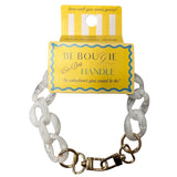 White chain handle with gold clasp on a yellow 'Be Bougie' card