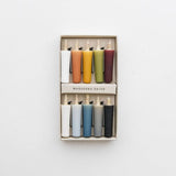 Set of colorful candles in a box on a white background