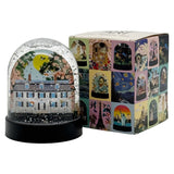 Decorative snow globe with artistic design and matching box on a white background