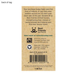 Back of tag for a Best Friends Animal Society product, printed on a brown kraft paper-like background with product details, a barcode, and certification logos including Fairtrade and GOTS.