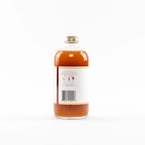 Bottle of syrup with a label on a white background