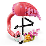 Toy flamingo with pink feathers and a black beak on a white background