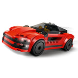 Red and black toy car made of interlocking bricks on a white background