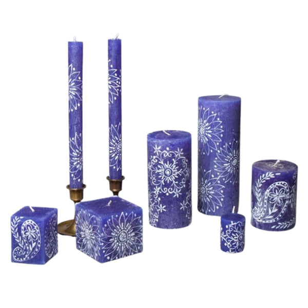 Set of blue candles with white patterns on a white background