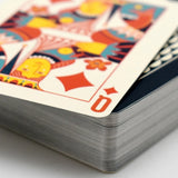 Stack of playing cards with a Queen of Diamonds card on top