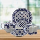 Ceramic tableware set with blue floral patterns on a wooden surface.