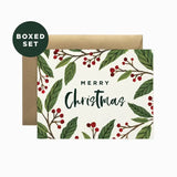 Christmas card with green leaves and red berries on a white background, featuring a brown envelope.
