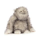 Plush toy resembling a creature with gray and white fur on a white background