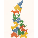 A set of colorful wooden animal stacking blocks arranged in a tower on a plain off-white background.