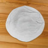 White sailor hat on a wooden surface