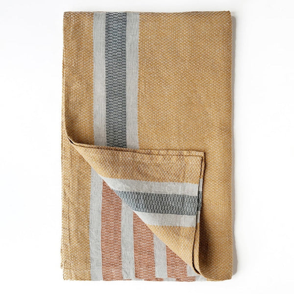 Folded woven blanket with striped pattern on a white background