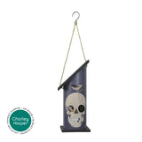 Hanging bird feeder with skull design and 'Charley Harper' logo.