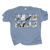 A light blue crewneck t-shirt featuring a graphic print that spells 'BIRD NERD' using different bird illustrations in each letter box, displayed on a white background.