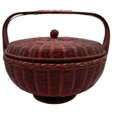 Red wicker basket with a lid on a white background
