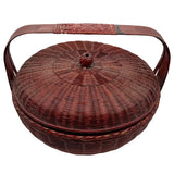 Woven basket with lid and handles on a white background