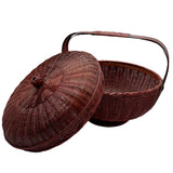 Wicker basket with a lid on a white background