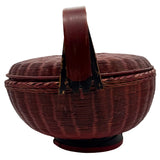 Wicker basket with a handle on a white background