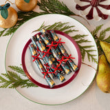 Decorative Christmas cracker on a plate with festive background
