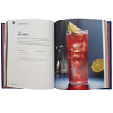 Open book showing a recipe for a red cocktail with a glass and lime slice on a white background