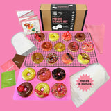 Mochi donut kit with various colored donuts on a pink background