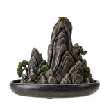 Decorative mountain-shaped incense burner on a white background