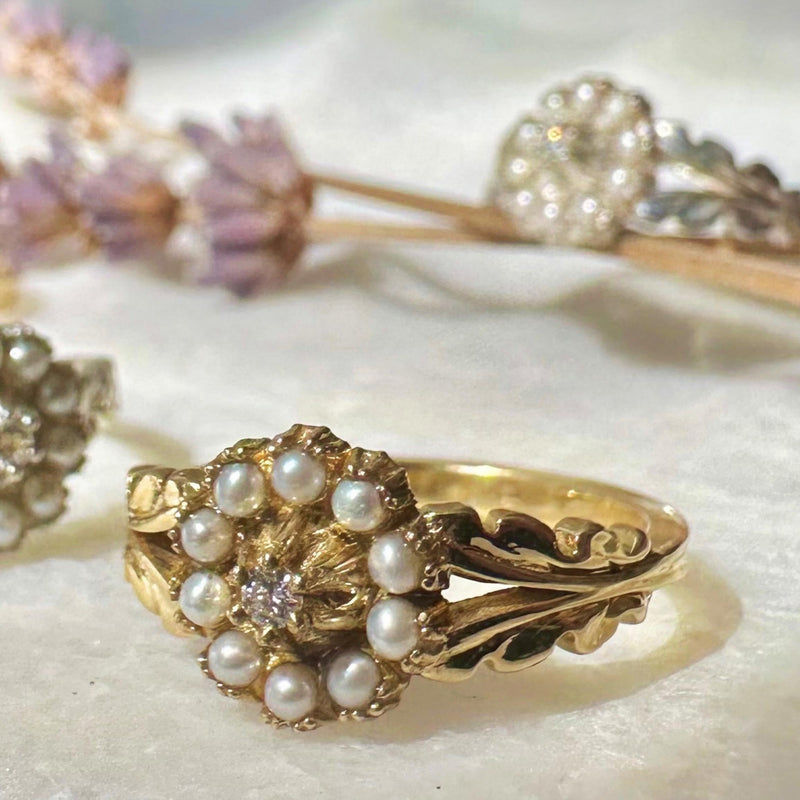 Gold ring with pearls on a textured surface