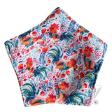 Colorful fabric with rooster and floral pattern on a white background