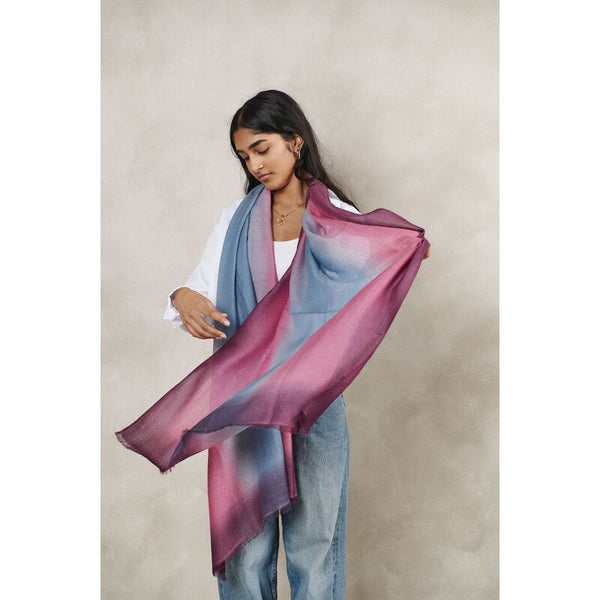 Woman wearing a colorful scarf with a neutral background