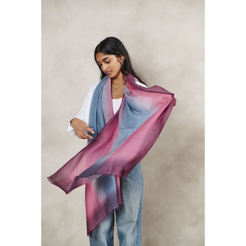 Woman wearing a colorful scarf with a neutral background