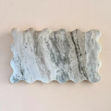 Marble stone with wavy edge on a beige background