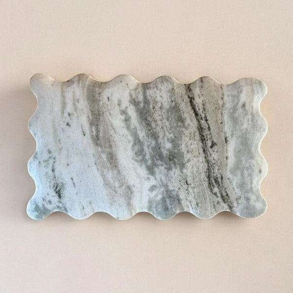 Marble stone with wavy edge on a beige background