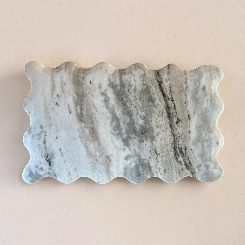 Marble stone with wavy edge on a beige background