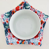 White plate on a colorful floral-patterned cloth