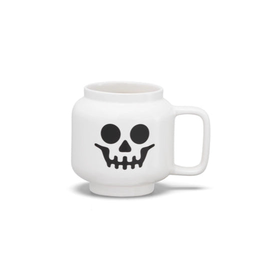 White mug with a black skull design on a white background