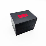 Black rectangular box with a red label on a white background