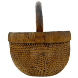 Woven basket with a handle on a white background