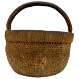 Woven basket with a wooden handle on a white background